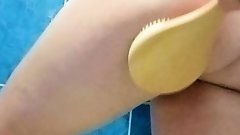 IN THE SHOWER I SPRAY MYSELF WITH A SCRUB I RUB THE GEL WITH A BRUSH